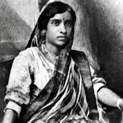 A black-and-white photograph featuring Kesarbai Kerkar among other Indian classical musicians in a traditional setting.